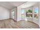 Bright living area featuring wood floors, natural light from large windows, and patio access at 410 Aloha Dr, Henderson, NV 89015