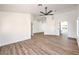 Spacious living room with wood-look floors and fresh white paint; access to other rooms at 410 Aloha Dr, Henderson, NV 89015