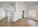 Open-concept living room with wood-look floors, fresh white paint, and an open view to the kitchen at 410 Aloha Dr, Henderson, NV 89015