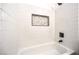 Tiled shower with integrated soap/shampoo nook and modern fixtures at 410 Aloha Dr, Henderson, NV 89015