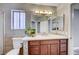 A well-lit bathroom features a large mirror, vanity with storage, and tiled walls at 4212 Estaban Ct, Las Vegas, NV 89110