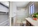 A well-lit bathroom features a glass shower, vanity with storage, and wood-look flooring at 4212 Estaban Ct, Las Vegas, NV 89110