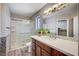 A well-lit bathroom features a shower, a large mirror, and a vanity with ample storage at 4212 Estaban Ct, Las Vegas, NV 89110