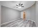 A neutral-painted bedroom with a closet door and wood-look flooring has a modern ceiling fan at 4212 Estaban Ct, Las Vegas, NV 89110