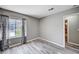 A bedroom with gray walls, wood floors, white trim, and a window is move-in ready at 4212 Estaban Ct, Las Vegas, NV 89110