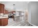 Open-concept kitchen features wood cabinets, stainless appliances, a center island, and wood-look flooring at 4212 Estaban Ct, Las Vegas, NV 89110