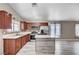 Modern kitchen with dark wood cabinets, stainless steel appliances, and a central island, stylish and functional at 4212 Estaban Ct, Las Vegas, NV 89110