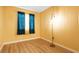 Stylish room with wooden floors, bright curtains, and a modern standing lamp, offering a cozy and contemporary ambiance at 4314 Flaming Ridge Trl, Las Vegas, NV 89147