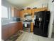 The kitchen features tile flooring, wood cabinetry, and modern appliances including a stainless-steel gas range at 4314 Flaming Ridge Trl, Las Vegas, NV 89147
