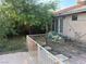 View of the backyard with mature trees and bushes, providing shade at 4928 E Philadelphia Ave, Las Vegas, NV 89104