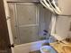 Bathroom with shower, toilet, sliding doors decorated with butterflies, and marble countertops at 4928 E Philadelphia Ave, Las Vegas, NV 89104
