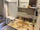 Outdated bathroom with a marble countertop, sink, toilet, and some personal care products at 4928 E Philadelphia Ave, Las Vegas, NV 89104