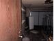 Interior garage view with storage shelves, white refrigerator, and garage door in the background at 4928 E Philadelphia Ave, Las Vegas, NV 89104
