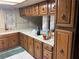 Kitchen with tile countertops, wooden cabinets with door pulls, sink, and rug on the floor at 4928 E Philadelphia Ave, Las Vegas, NV 89104