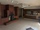 Living room with brick fireplace and open floor plan to kitchen at 4928 E Philadelphia Ave, Las Vegas, NV 89104