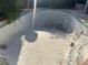 A large in-ground pool requires cleaning and maintenance, with greenery surrounding the perimeter at 4928 E Philadelphia Ave, Las Vegas, NV 89104