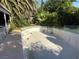 Empty swimming pool with tiled trim and steps surrounded by mature landscaping at 4928 E Philadelphia Ave, Las Vegas, NV 89104