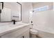 Bathroom showcasing a single vanity with a marble countertop and a tub with tiled walls at 5417 Bible Cir, North Las Vegas, NV 89031