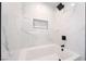 Modern bathroom features white marble tile walls, black hardware, and a built-in shelf at 5417 Bible Cir, North Las Vegas, NV 89031