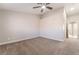 Spacious bedroom with neutral carpet, ceiling fan, and an ensuite bathroom entrance at 5417 Bible Cir, North Las Vegas, NV 89031