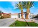 Charming single-story home boasts desert landscaping, two palm trees, and a two-car garage at 5417 Bible Cir, North Las Vegas, NV 89031