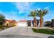 Charming single-story home boasts desert landscaping, two palm trees, and a two-car garage at 5417 Bible Cir, North Las Vegas, NV 89031