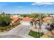 Charming residence with a garage, terra cotta roof, drought-tolerant landscaping, and twin palm trees at 5417 Bible Cir, North Las Vegas, NV 89031