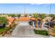 Beautiful home with a terra cotta roof, desert landscaping, and prominent palm trees at 5417 Bible Cir, North Las Vegas, NV 89031