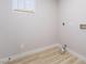 A light and bright laundry room with vinyl flooring and white walls at 5417 Bible Cir, North Las Vegas, NV 89031