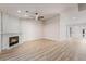 Bright living room featuring a modern fireplace, ceiling fan, and light wood-look flooring at 5417 Bible Cir, North Las Vegas, NV 89031
