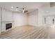 Bright living room featuring a modern fireplace, ceiling fan, and light wood-look flooring at 5417 Bible Cir, North Las Vegas, NV 89031