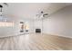 Bright living room featuring a modern fireplace, ceiling fan, and light wood-look flooring at 5417 Bible Cir, North Las Vegas, NV 89031