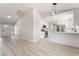 Open living area with wood floors, modern lighting, and stainless steel appliances in the kitchen at 5417 Bible Cir, North Las Vegas, NV 89031