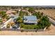 Overhead shot of a white house with blue roof, surrounded by tall trees, in desert neighborhood at 5515 N Campbell Rd, Las Vegas, NV 89149
