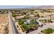 Elevated angle shows property with desert landscape and surrounding community in the distance at 5515 N Campbell Rd, Las Vegas, NV 89149