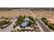 Wide aerial view of the home and neighborhood with an empty lot next door, showcasing its setting and location at 5515 N Campbell Rd, Las Vegas, NV 89149