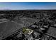 Scenic aerial shot showcasing the neighborhood with a unique home, contrasting against an empty desert lot at 5515 N Campbell Rd, Las Vegas, NV 89149