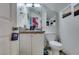 Small bathroom featuring a single sink vanity, a toilet, and a mirror with decorative wall hangings at 5515 N Campbell Rd, Las Vegas, NV 89149