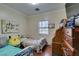Cozy bedroom with wood floors, natural light and comfortable furnishings at 5515 N Campbell Rd, Las Vegas, NV 89149