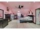 Bright bedroom featuring angled ceilings, wood floors, walk-in closet, and black furniture at 5515 N Campbell Rd, Las Vegas, NV 89149