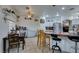 Well-lit dining area featuring a breakfast bar and tiled floor with an open layout to the kitchen area at 5515 N Campbell Rd, Las Vegas, NV 89149