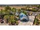 Aerial view of a white home with a blue-tiled roof and palm trees, adding a vibrant and unique charm at 5515 N Campbell Rd, Las Vegas, NV 89149