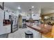 Modern kitchen features stainless steel appliances, bright white cabinets, and an extended countertop bar at 5515 N Campbell Rd, Las Vegas, NV 89149