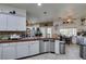 Traditional kitchen features white cabinets, tile backsplash, stainless steel appliances, and a tile floor at 5515 N Campbell Rd, Las Vegas, NV 89149