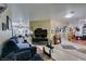 Open-concept living room with tile flooring, comfortable seating, and seamless transition to the dining area at 5515 N Campbell Rd, Las Vegas, NV 89149