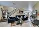 Inviting living room featuring tile flooring, a staircase, and comfortable seating arrangement at 5515 N Campbell Rd, Las Vegas, NV 89149
