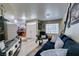 Bright living room showcasing a sofa, large windows, and seamless flow into the entrance area at 5515 N Campbell Rd, Las Vegas, NV 89149