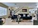 Comfortable living room featuring tile flooring, staircase, and a decorative glass coffee table at 5515 N Campbell Rd, Las Vegas, NV 89149