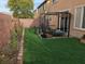 Cozy backyard with artificial grass, pergola, and decorative lighting at 5709 Nobleton Ct, North Las Vegas, NV 89081