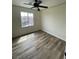Bedroom features wood floors, neutral walls, and a window for natural light at 5709 Nobleton Ct, North Las Vegas, NV 89081